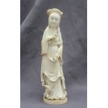 A 19th century Japanese ivory figure of a Geisha with kimono slipping off her shoulder and fan in