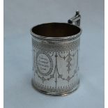 A Victorian silver christening mug, of tapering cylindrical form decorated with swags and flowers,