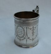 A Victorian silver christening mug, of tapering cylindrical form decorated with swags and flowers,