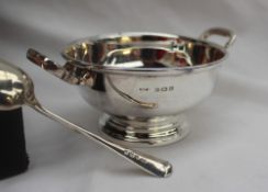 A George V silver twin handled sugar basket and spoon, Birmingham, 1935, W F Mitchell,