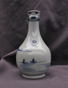 A Japanese porcelain vase decorated with dwellings on a lake,