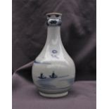 A Japanese porcelain vase decorated with dwellings on a lake,