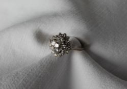 A diamond cluster ring, set with three tiers of round brilliant cut diamonds, ranging from 0.