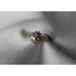 A diamond cluster ring, set with three tiers of round brilliant cut diamonds, ranging from 0.