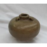 A Chinese Song dynasty stoneware three handled vase, with a green and brown glaze and unglazed base,
