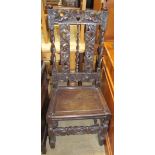 A 19th century oak low countries dining chair with a carved back and solid seat on turned legs,