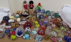 Assorted glass paperweights together with a Murano glass clown, hardstone eggs,