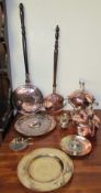 A copper spirit kettle on a stand together with another copper kettle, copper bed warming pans,