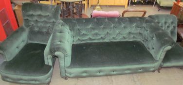 A Victorian upholstered three piece suite including a chesterfield settee together with a pair of