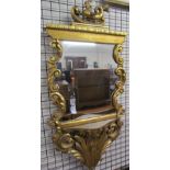 A gilt wall mirror with sea creature terminal scrolls and leaves