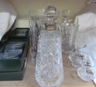 A silver topped decanter together with other glasswares