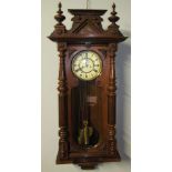 A Vienna regulator type wall clock, with a carved and turned cornice,