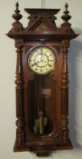 A Vienna regulator type wall clock, with a carved and turned cornice,