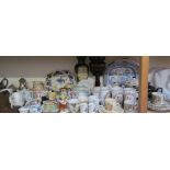A large lot including a blue and white meat plate and commemorative jugs together with motto wares,