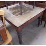 A pine kitchen table of square form on turned legs