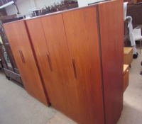 A G-plan teak bedroom suite comprising a triple wardrobe, double wardrobe,