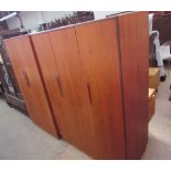 A G-plan teak bedroom suite comprising a triple wardrobe, double wardrobe,