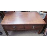 A mahogany coffee table with a pair of drawers and lions head handles on square legs