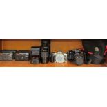 A Leica Mini 35mm camera together with a Leica Mini II, a Minolta DNYAX 505Si,