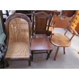 An early 19th century bergère nursing chair together with an office chair and a dining chair