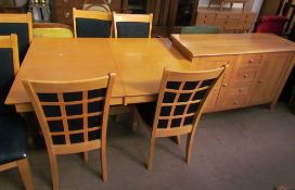 A modern dining room suite comprising an extending dining table,