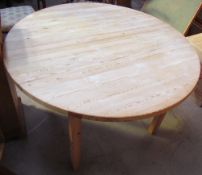 A 20th century pine table of circular form on square legs