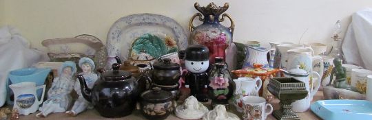 A pair of continental porcelain figures together with water jugs, teapots, commemorative wares,