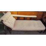 An Edwardian upholstered chaise longue on turned legs