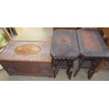 An oriental carved camphor wood coffer together with a pair of side tables carved with elephants