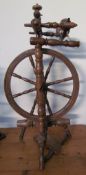 A large fruitwood spinning wheel with turned spindles