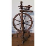 A large fruitwood spinning wheel with turned spindles