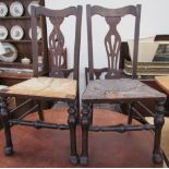 A set of seven provincial oak dining chairs with rush seats