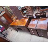 A walnut bedroom suite comprising a triple wardrobe, dressing table, tall boy and bed,