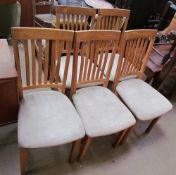 A set of six stick back dining chairs with upholstered seats together with a rectangular kitchen