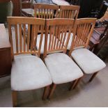 A set of six stick back dining chairs with upholstered seats together with a rectangular kitchen