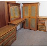 A pine and wicker bedroom suite including a single wardrobe, dressing table, wall mirror,