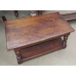 A 20th century oak coffee table with a rectangular top on turned legs and an undertier