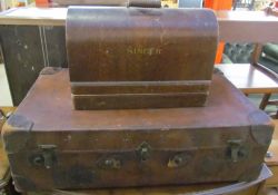 A brown leather suitcase together with a Singer sewing machine in a case