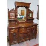 An Edwardian walnut mirror back sideboard, with a moulded cornice and three mirrors,