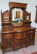 An Edwardian walnut mirror back sideboard, with a moulded cornice and three mirrors,