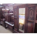An early 20th century oak bedroom suite comprising a wardrobe with mirrored door,
