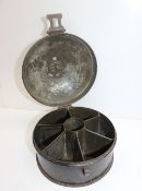 A 19th century toleware spice container, the circular lid enclosing a six division interior,