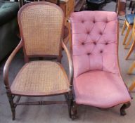 A Victorian rosewood nursing chair with button back upholstery on scrolling legs and feet together