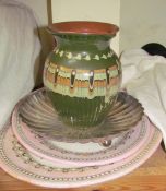 A pottery jug decorated with swirling decoration together with pink and white meat plates etc