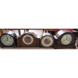 A bakelite mantle clock together with two oak mantle clocks and a walnut mantle clock