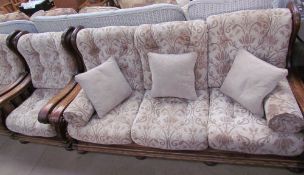 An upholstered three piece suite with an oak frame