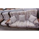 An upholstered three piece suite with an oak frame