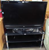 An LG 42” flat screen television on a black glass and chrome stand (Sold as seen,