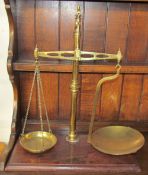 A set of brass beam scales on a mahogany base, stamped R Sutcliffe, Maker,