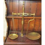 A set of brass beam scales on a mahogany base, stamped R Sutcliffe, Maker,